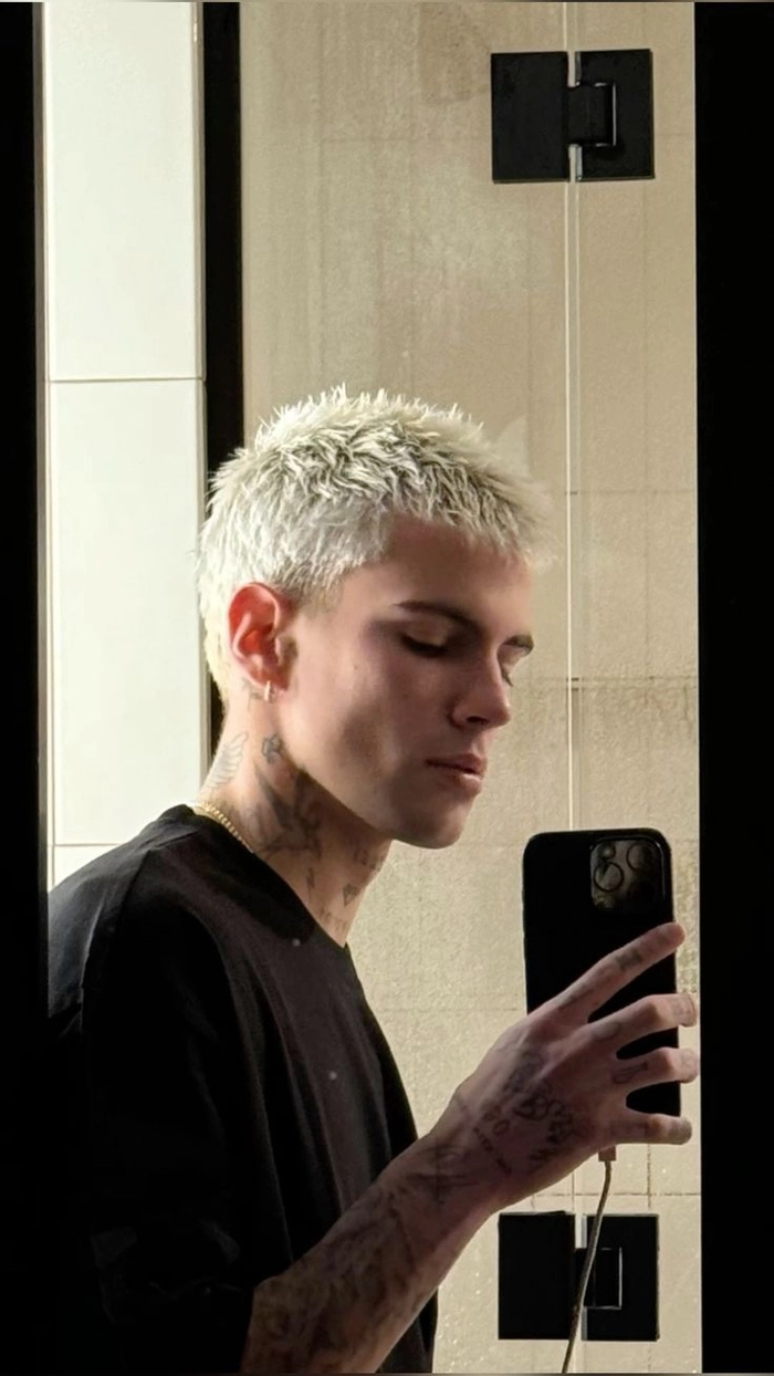 Image title: Modern taper fade hairstyle idea for white men ALT: White man with a clean modern taper fade haircut, showcasing a stylish men haircut idea